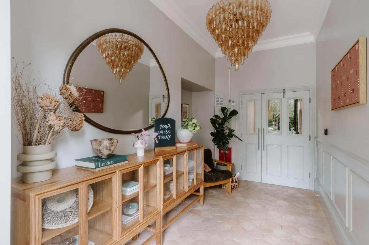 Hallway with mirror and wooden dresser at Mason & Fifth, Primrose Hill